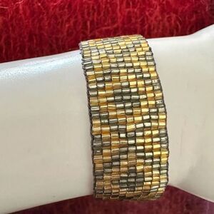 Gold tone and grey beaded tassel adjustable bracelet
